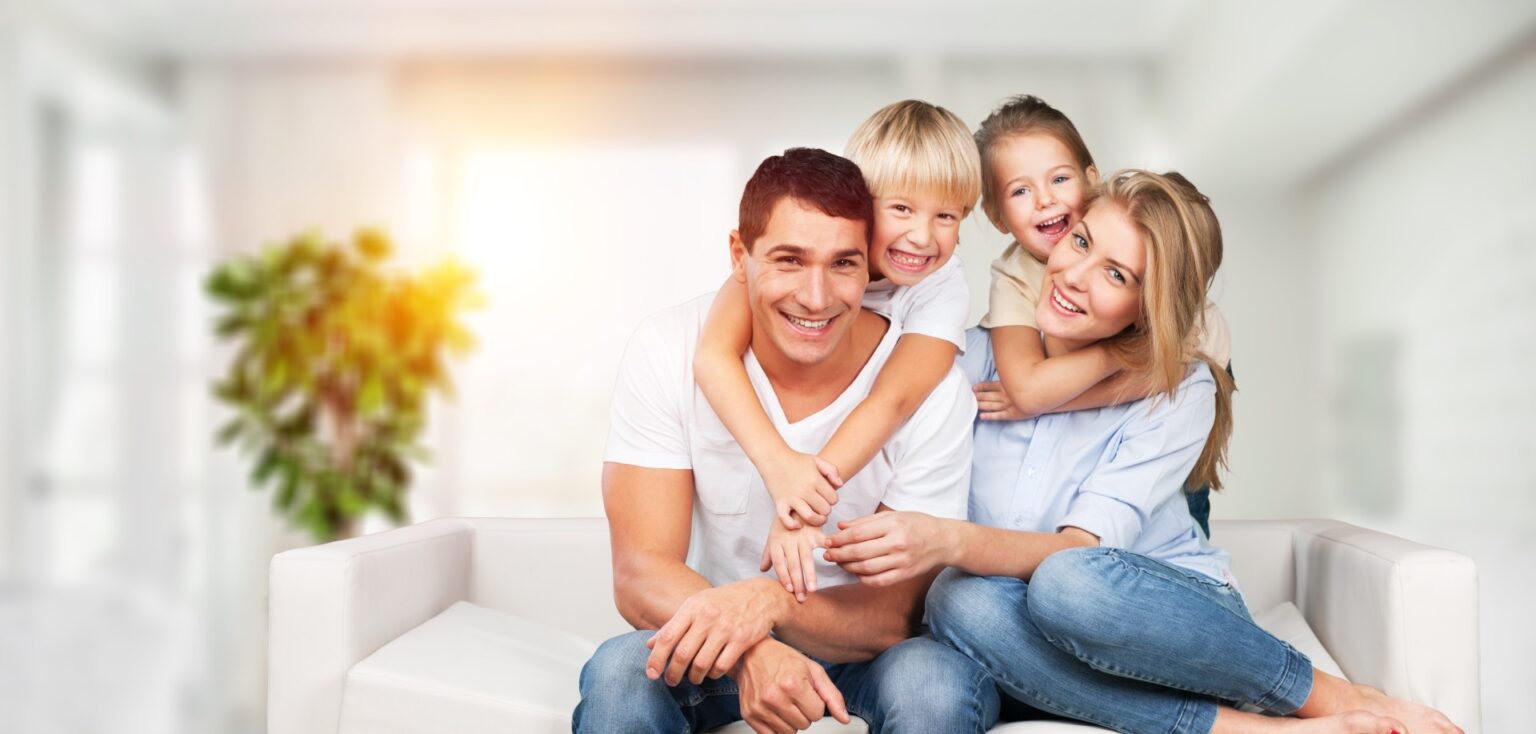 Beautiful smiling lovely family sitting on sofa